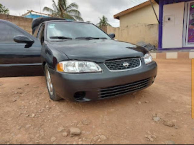 A second hand used nissan sentra -2003  GXE sedan,  4D model (actually handled by woman) for sale. - 2/6