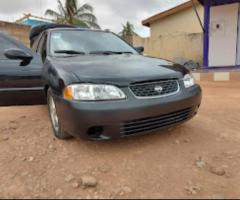 A second hand used nissan sentra -2003  GXE sedan,  4D model (actually handled by woman) for sale. - 2