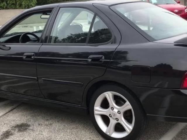A second hand used nissan sentra -2003  GXE sedan,  4D model (actually handled by woman) for sale. - 6/6